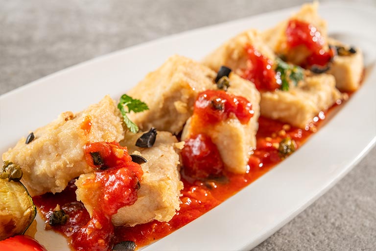 Swordfish with garlic tomato sauce and summer vegetables.